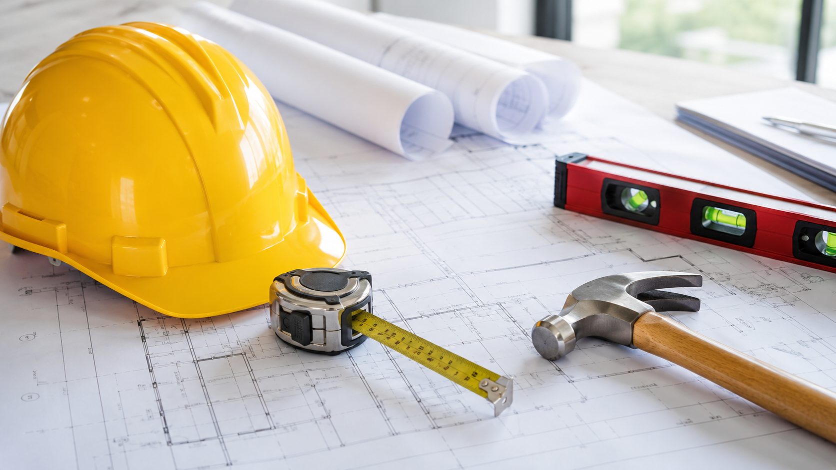 Contractor insurance in Surrey BC — hard hat, blueprints and tools on a job site