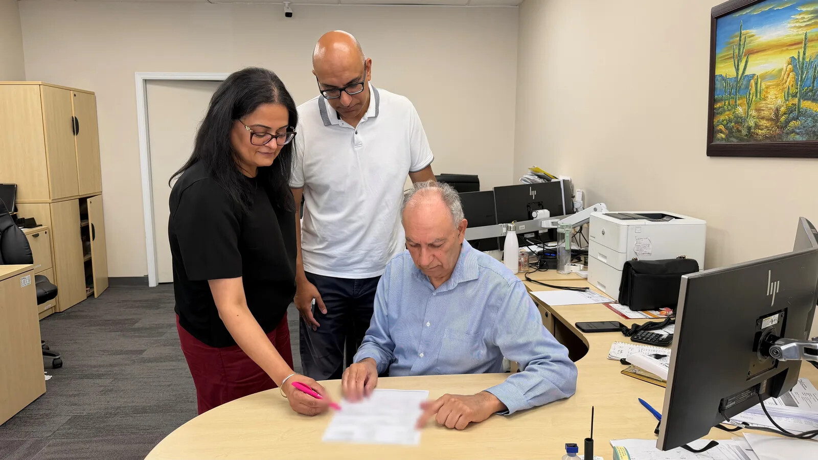 A licensed Prime Insurance advisor reviewing a home insurance declarations page at the Surrey brokerage